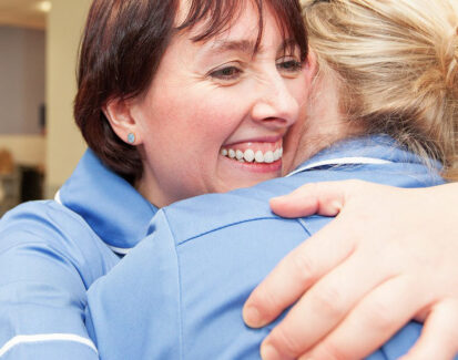 Two nurses hugging